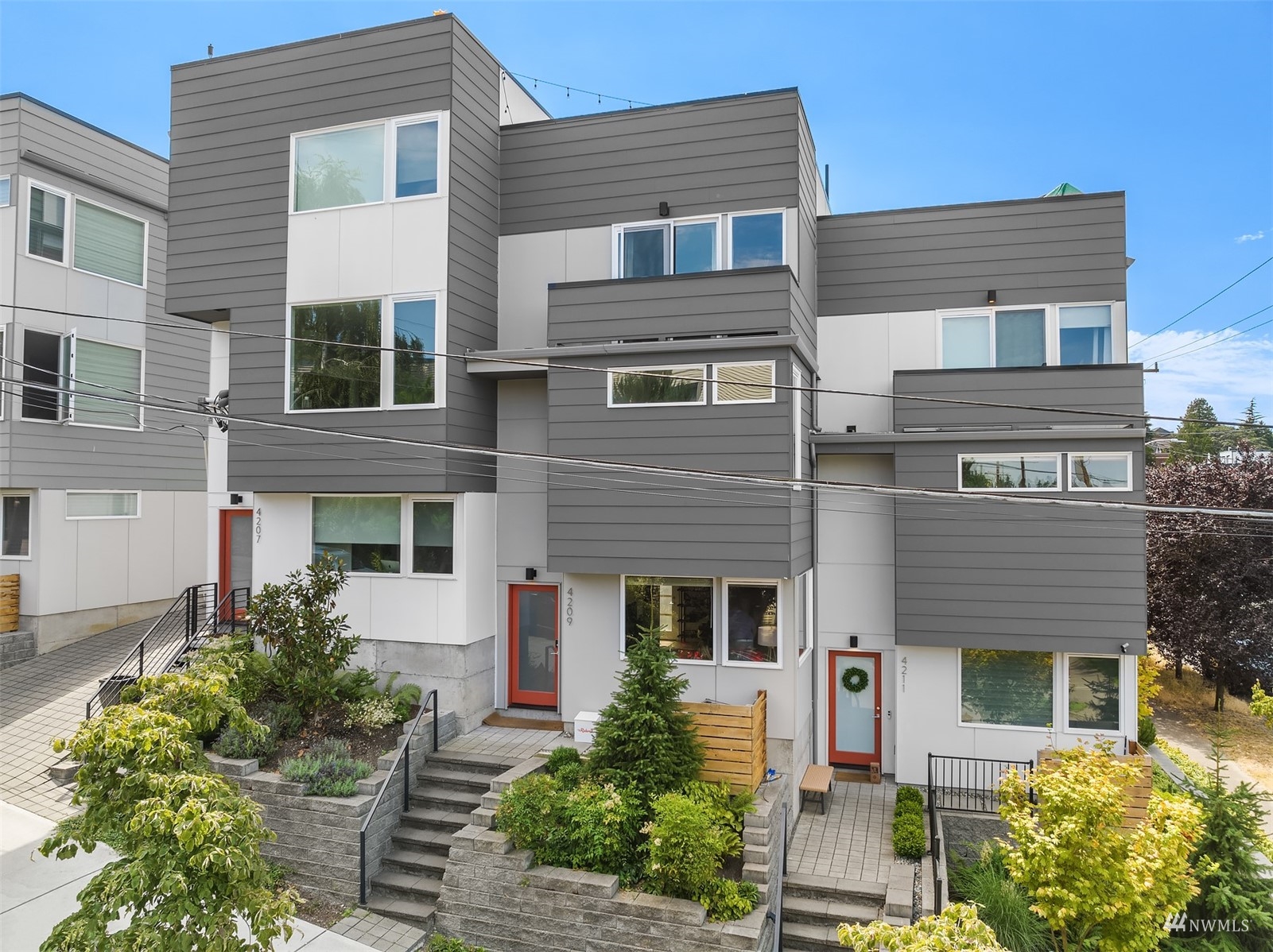 4209 Southwest Frontenac Street Seattle, WA 98136 - Photo 5 of 36 a front view of a house with garden
