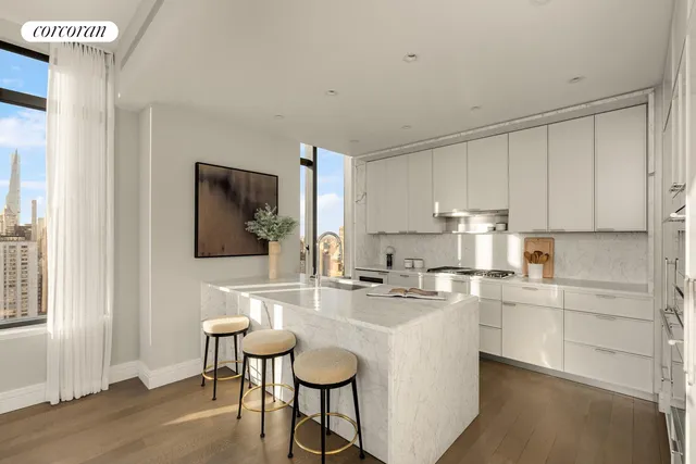 a dining room with furniture a chandelier and window