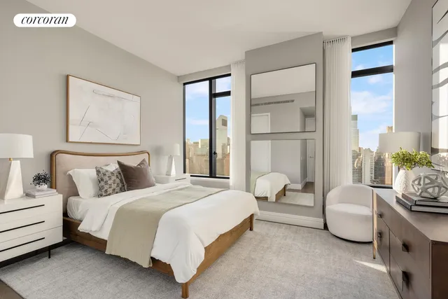 a bedroom with a large bed and wooden floor