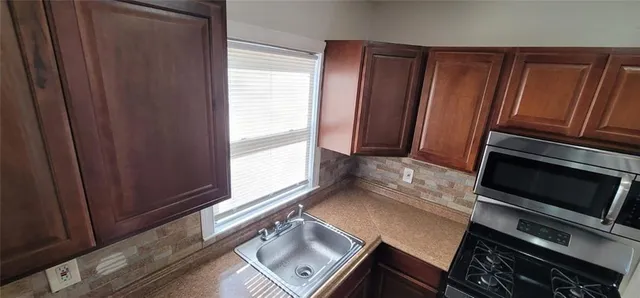 a view of an oven and wooden floor
