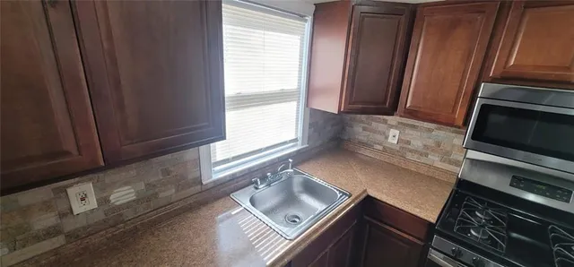 a bathroom with a sink toilet and mirror