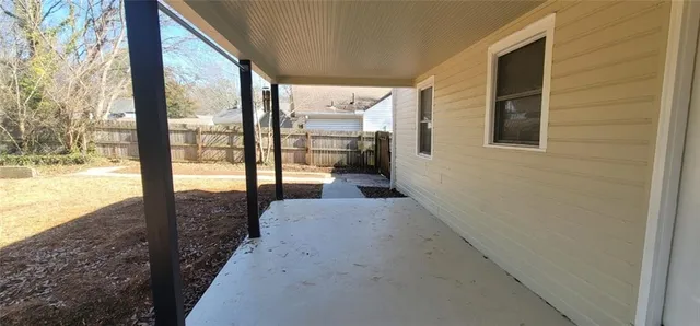 a view of a porch with a floor to ceiling window and an outdoor view