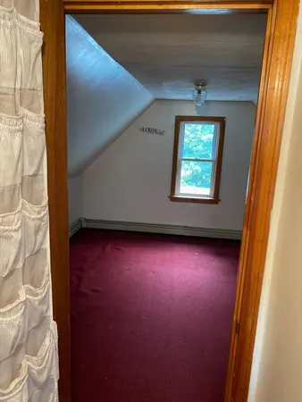 a view of room with window and wooden floor