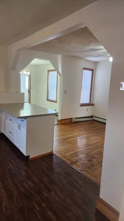 a view of room with window and wooden floor