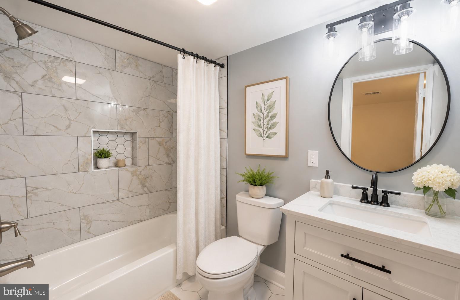 803 Johnson Avenue Silver Spring, MD 20904 - Photo 10 of 20 a bathroom with a sink a mirror a toilet and a bathtub