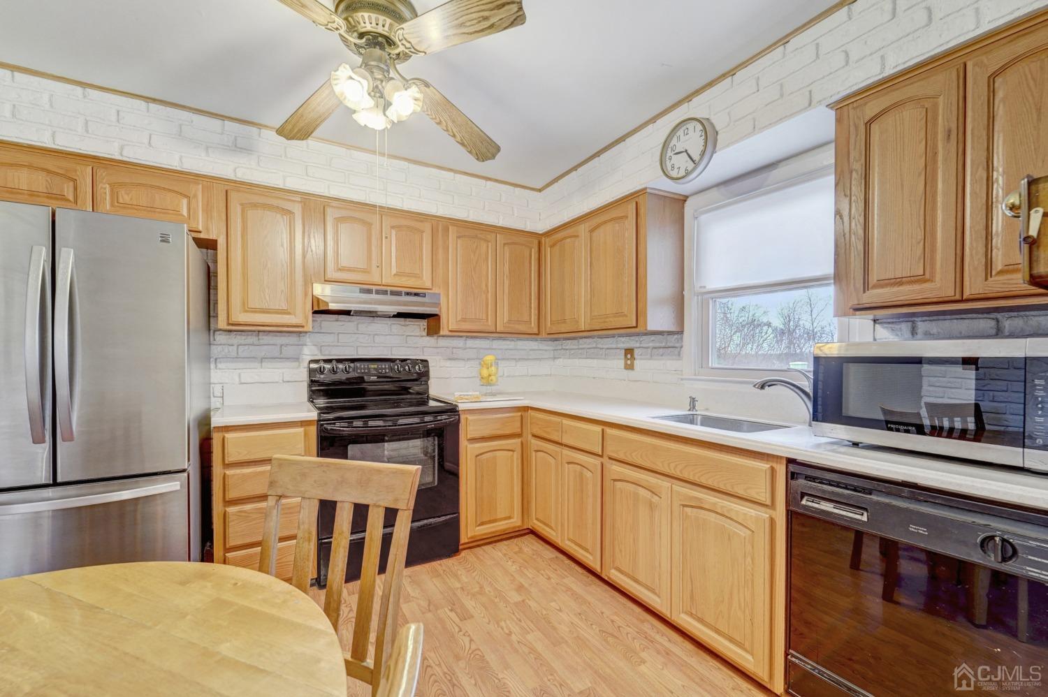 23 Hillside Terrace Andover, NJ 07821 - Photo 5 of 20 a kitchen with a stove a sink and a refrigerator
