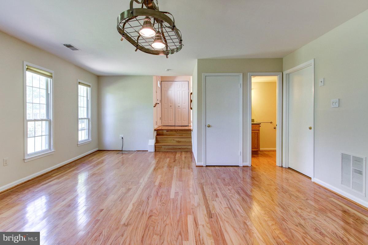 12301 Coleraine Court Reston, VA 20191 - Photo 14 of 29 an empty room with wooden floor cabinet and windows