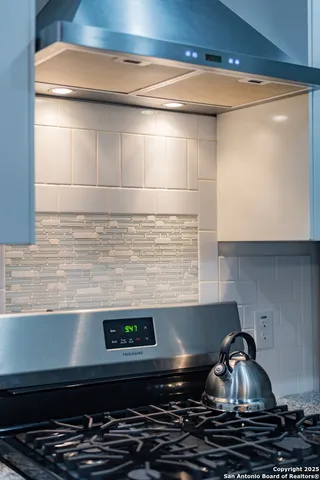 a stove top oven sitting inside of a kitchen