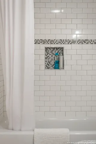 a bathroom with a shower and a tub