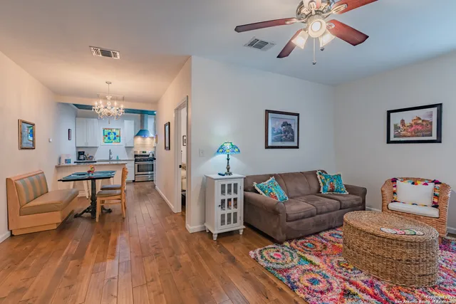 a living room with furniture and a wooden floor