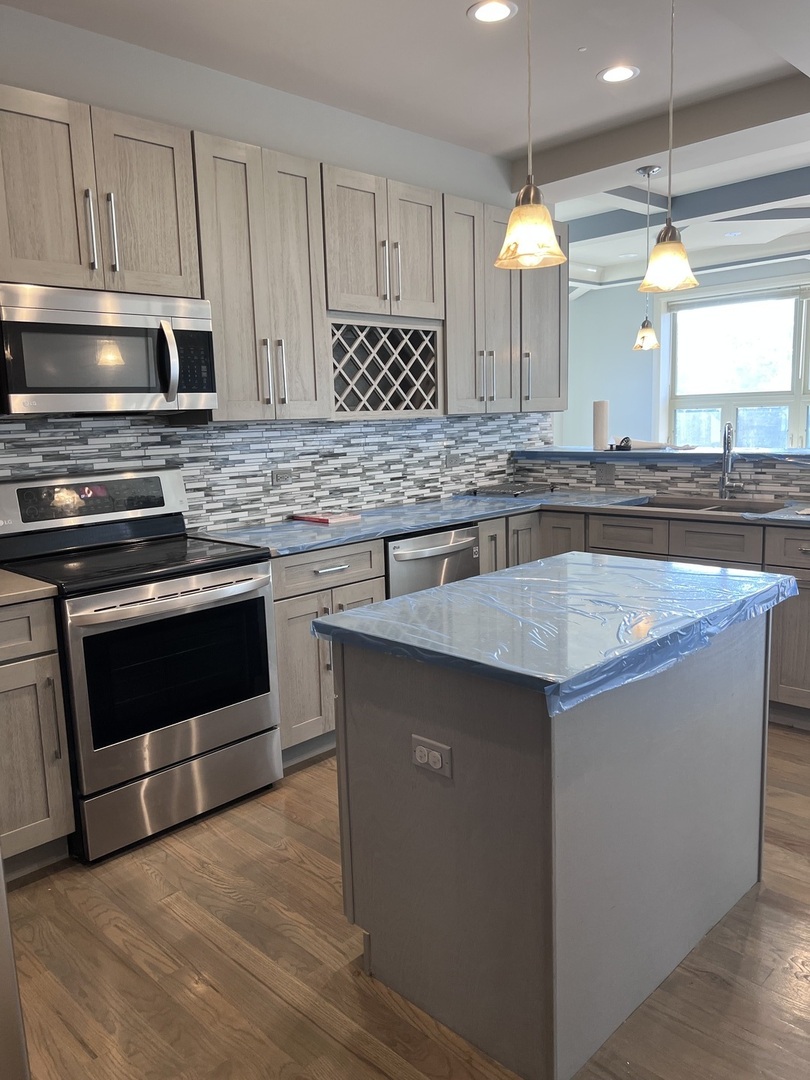1208 East 64th Street, Unit 2B Chicago, IL 60637 - Photo 5 of 19 a kitchen with a stove and a sink
