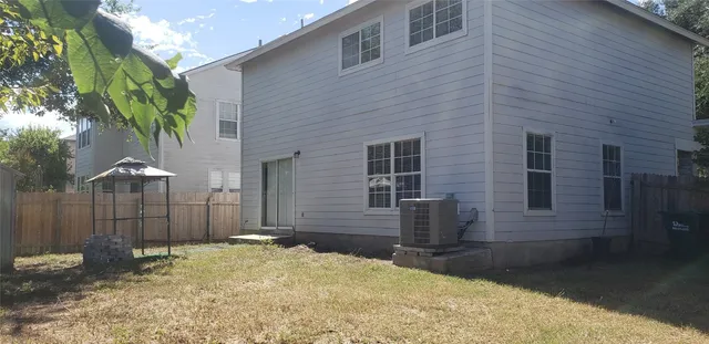 a backyard of a house with plants and trees