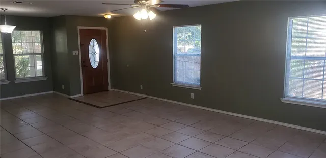 an empty room with windows and closet