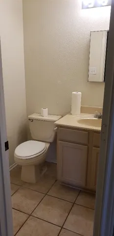 a bathroom with a toilet a sink and mirror
