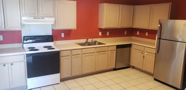 a kitchen with a sink cabinets and appliances