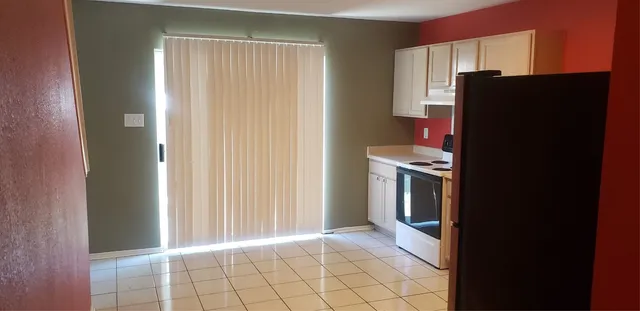 a kitchen with a refrigerator and a stove