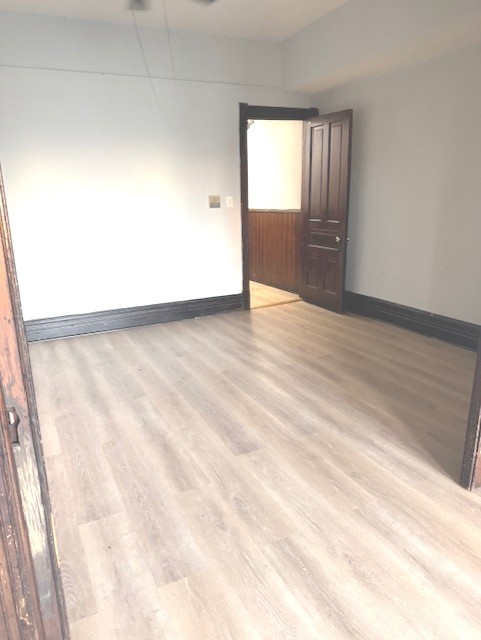 2150 North Halsted Street, Unit 3F Chicago, IL 60614 - Photo 12 of 16 a view of empty room with wooden floor and fan