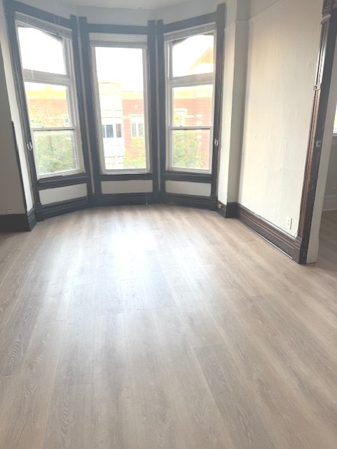 2150 North Halsted Street, Unit 3F Chicago, IL 60614 - Photo 6 of 16 an empty room with wooden floor and windows