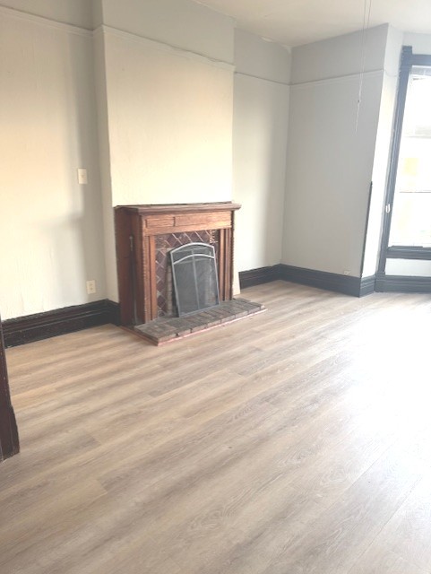 2150 North Halsted Street, Unit 3F Chicago, IL 60614 - Photo 7 of 16 a view of an empty room with wooden floor and a window