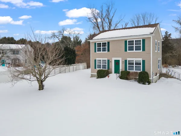 a view of a house with a snow in the yard