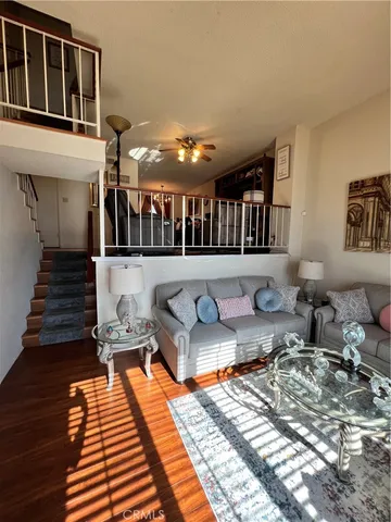 a view of a patio with couches chairs and wooden floor
