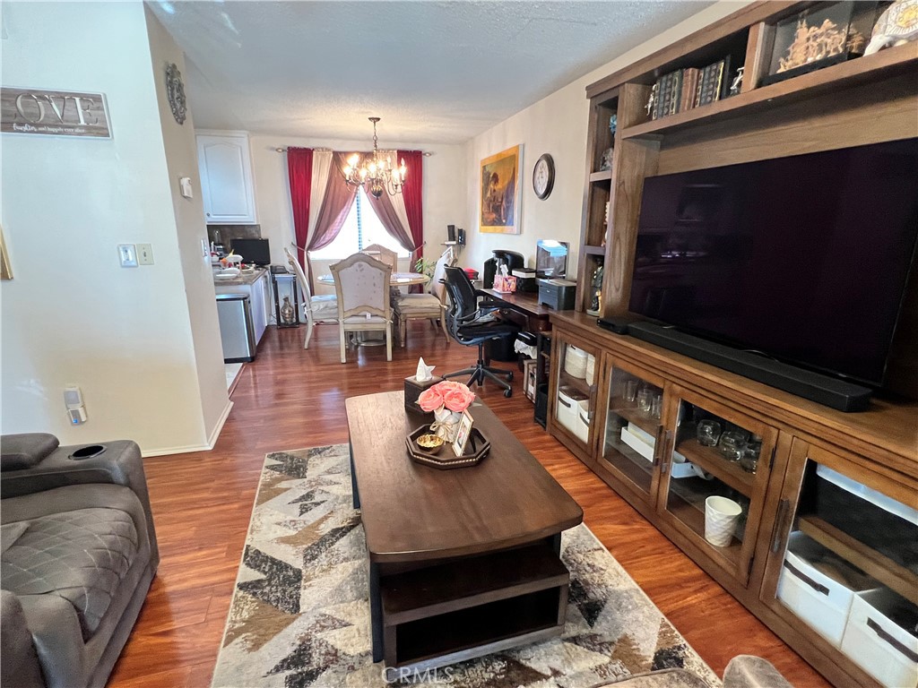 19230 Wyandotte Street, Unit 14 Reseda, CA 91335 - Photo 9 of 10 a living room with furniture and a flat screen tv