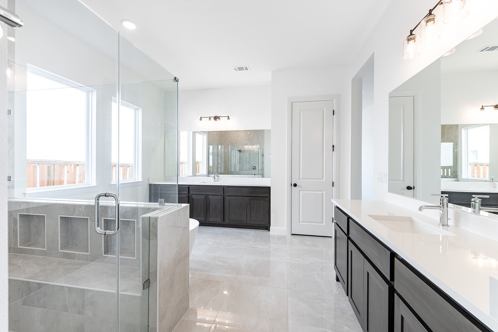 304 Barnstorm Lane Georgetown, TX 78633 - Photo 14 of 40 a large bathroom with a double vanity sink a mirror and a bathtub