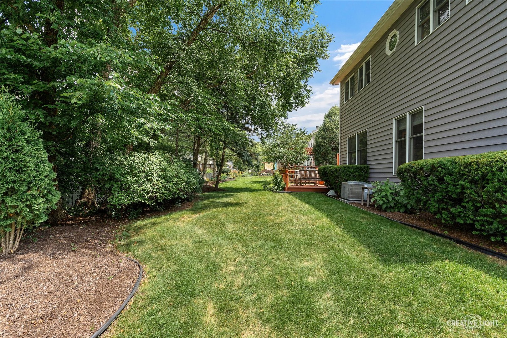 567 Roxbury Drive Naperville, IL 60565 - Photo 33 of 36 a view of a backyard with table and chairs and a large tree