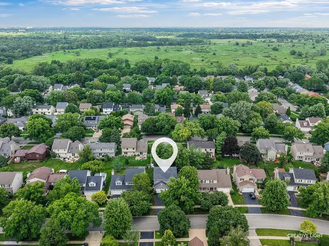 an aerial view of a house with a yard