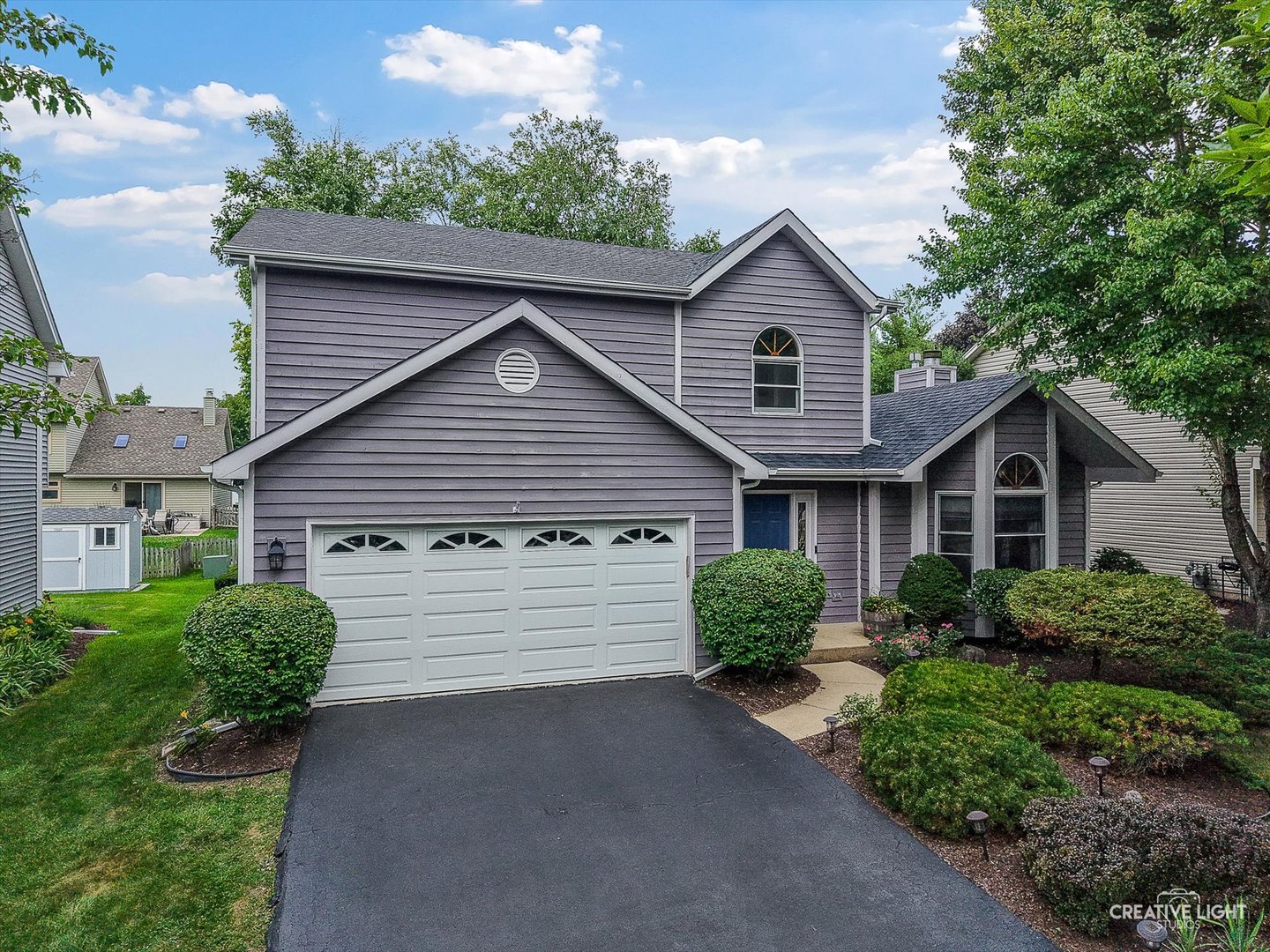 567 Roxbury Drive Naperville, IL 60565 - Photo 4 of 36 a front view of a house with a yard and garage