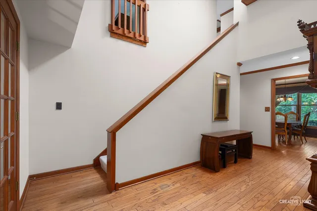 a view of an entryway with wooden floor and stairs