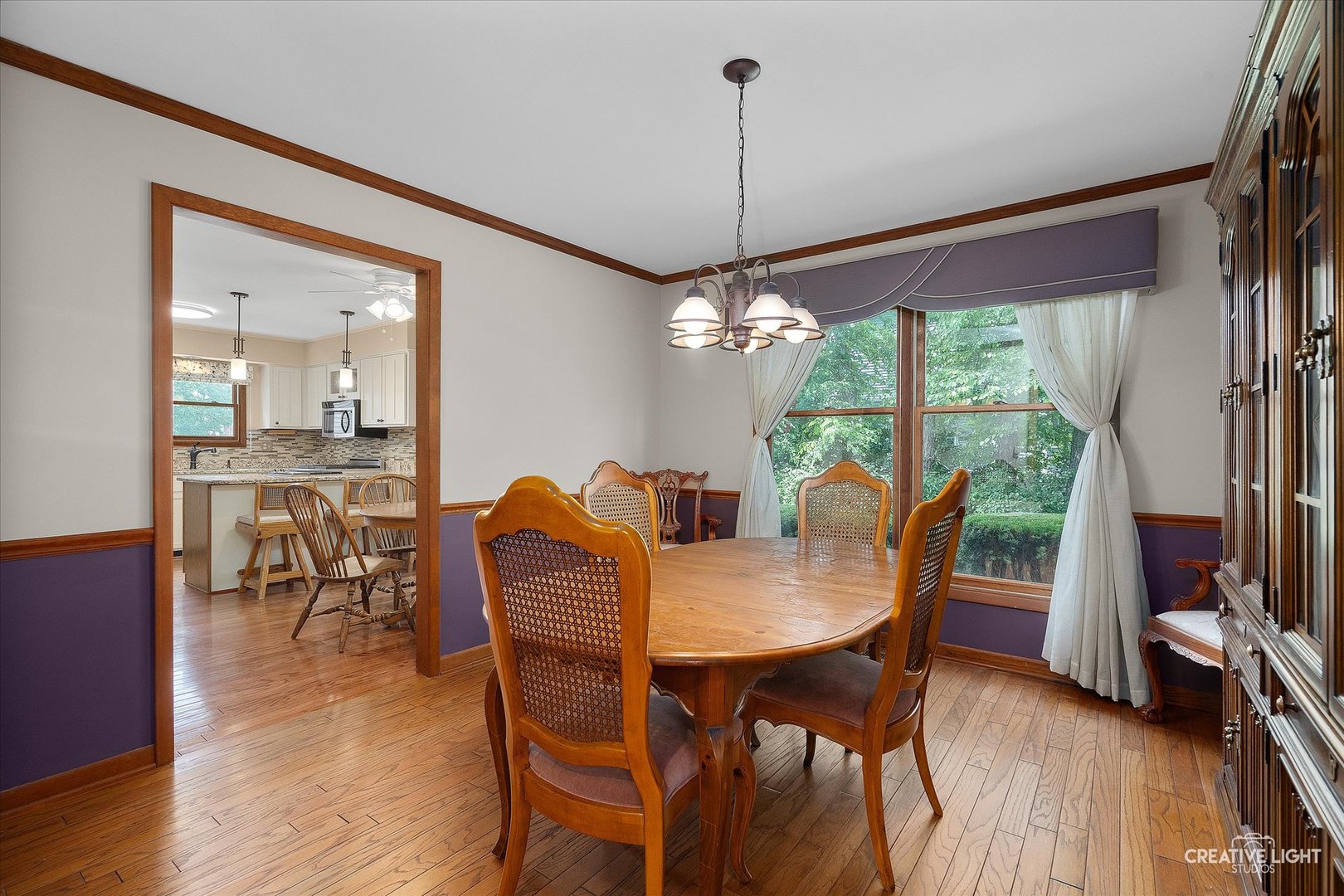 567 Roxbury Drive Naperville, IL 60565 - Photo 10 of 36 a view of a dining room with furniture window and wooden floor