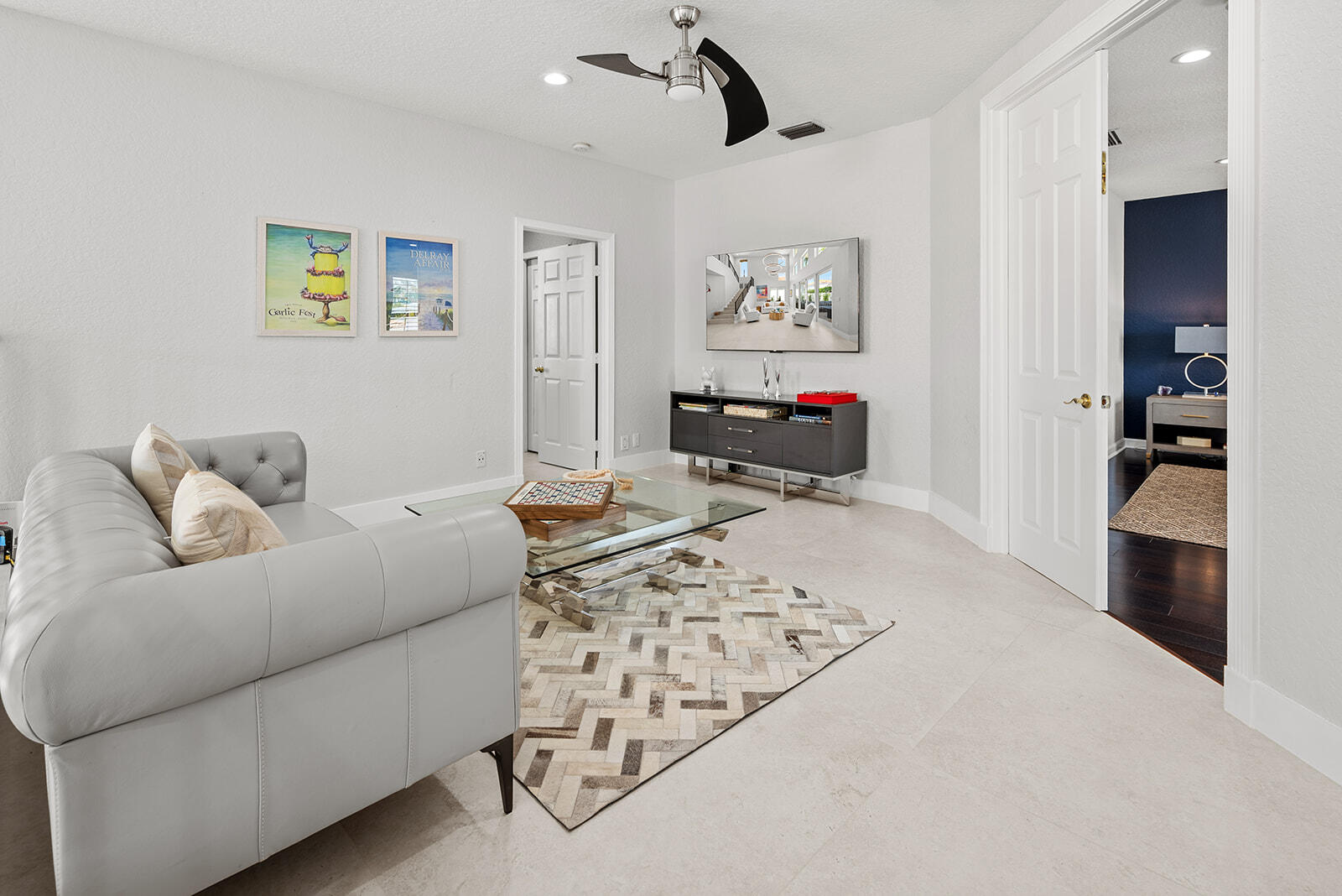 4267 Northwest 65th Place Boca Raton, FL 33496 - Photo 30 of 80 a living room with furniture and a flat screen tv