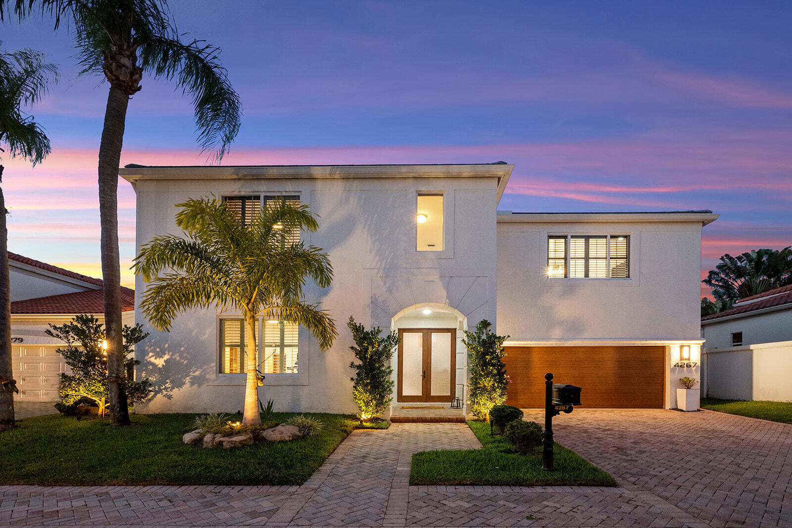 4267 Northwest 65th Place Boca Raton, FL 33496 - Photo 51 of 80 a front view of a house with garden