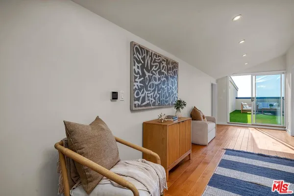 a bedroom with a bed and a potted plant