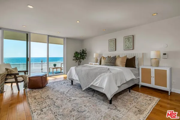 a spacious bedroom with a bed and a couch