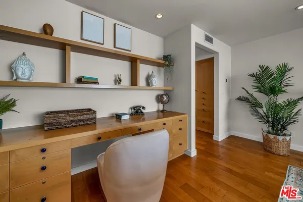 a bedroom with bed and dresser