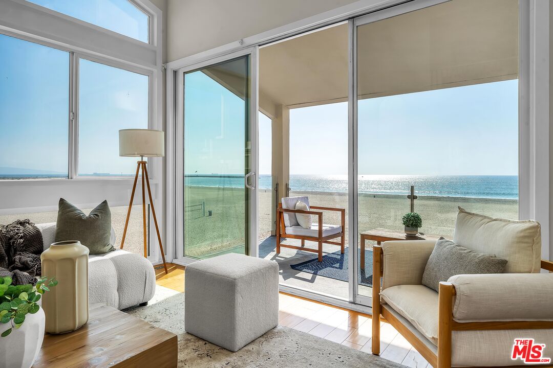 4 Lighthouse Street, Unit 13 Marina del Rey, CA 90292 - Photo 2 of 35 a living room with furniture and a floor to ceiling window