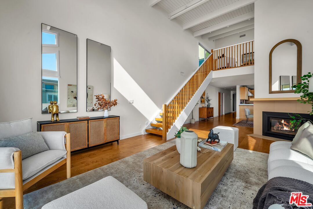 4 Lighthouse Street, Unit 13 Marina del Rey, CA 90292 - Photo 7 of 35 a living room with furniture and a fireplace