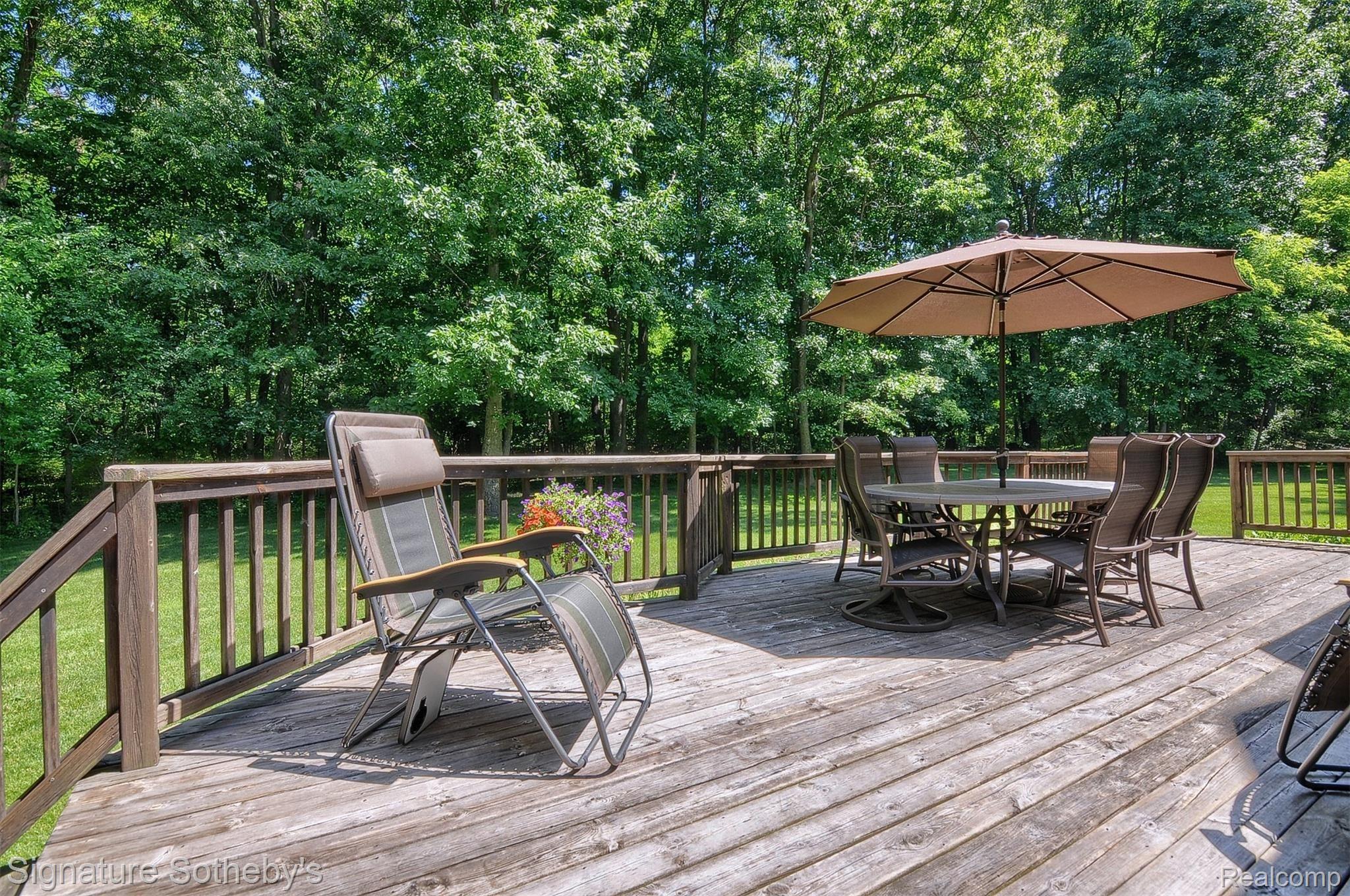 12293 Ivy Lane Fenton, MI 48430 - Photo 34 of 43 Deck in lush wooded yard