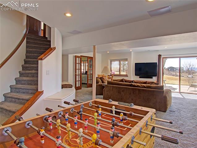 1165 Bowstring Road Monument, CO 80132 - Photo 21 of 27 Head downstairs to walk out basement to second famly room, game area and wet bar.