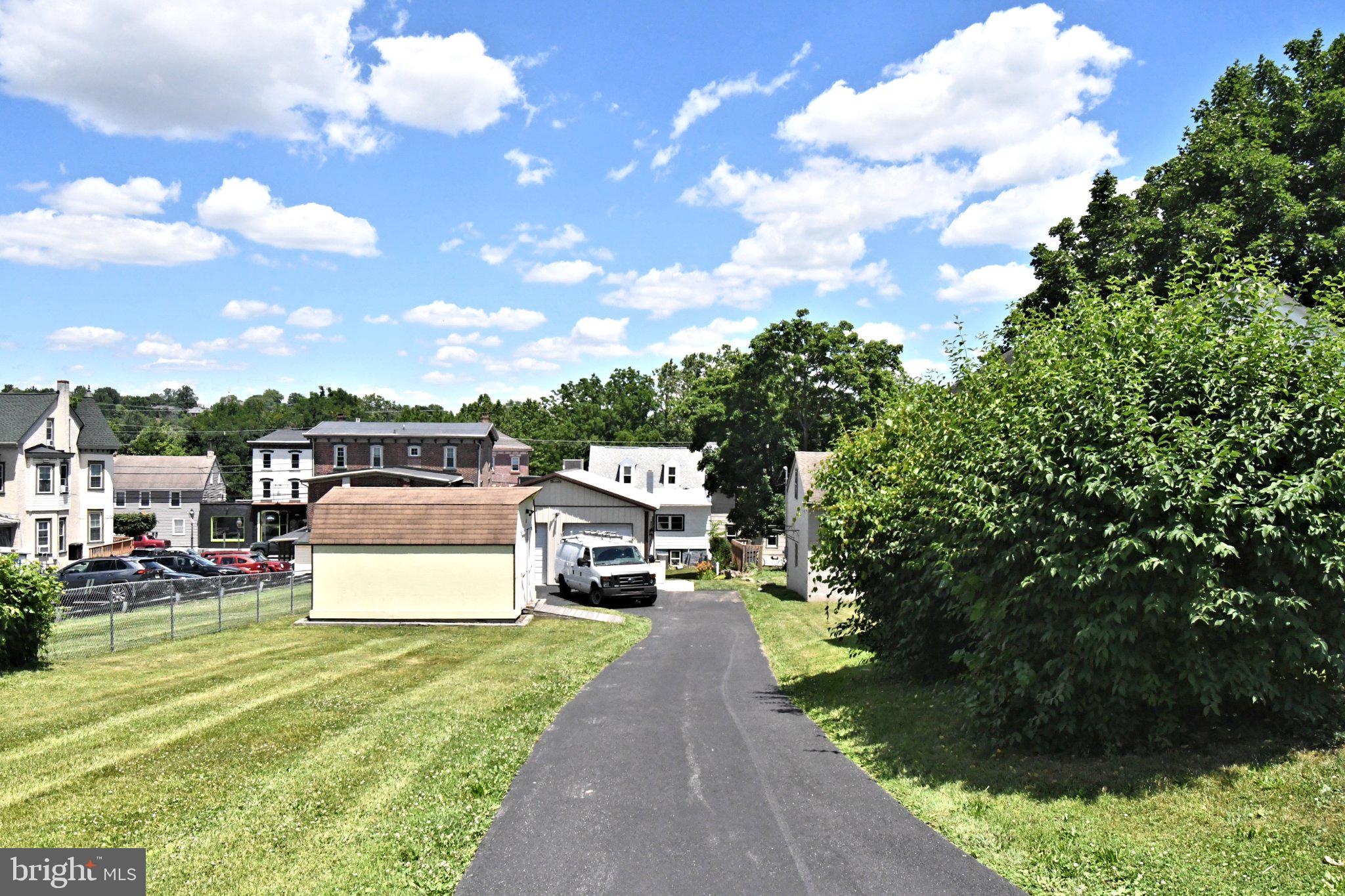 64 North Main Street Spring City, PA 19475 - Photo 5 of 26 Charming driveway with lush greenery.