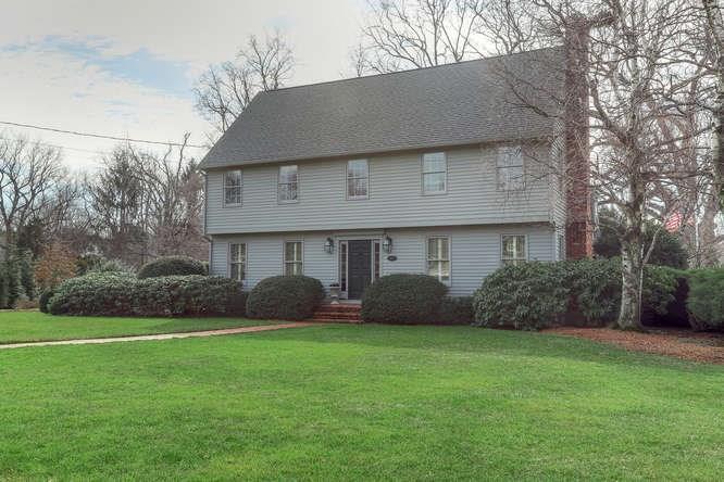a front view of a house with a garden and plants