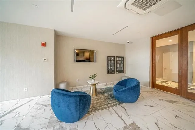 a living room with furniture a couch and a potted plant