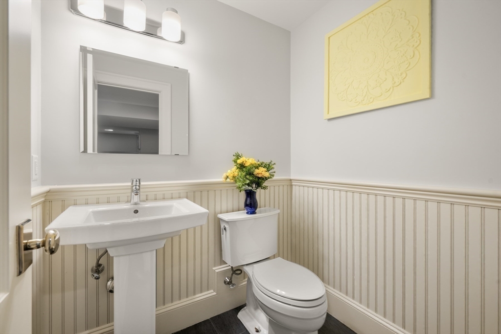 21 Cushing Road Wellesley, MA 02481 - Photo 23 of 31 a bathroom with a sink mirror and toilet