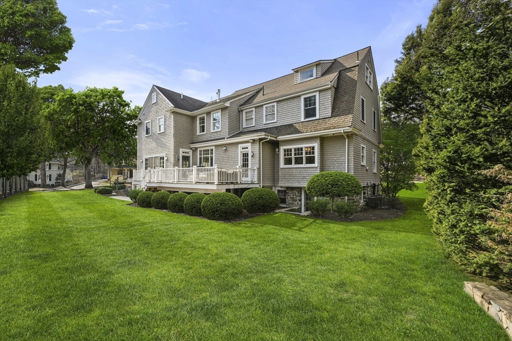 21 Cushing Road Wellesley, MA 02481 - Photo 29 of 31 a front view of a house with a garden and trees