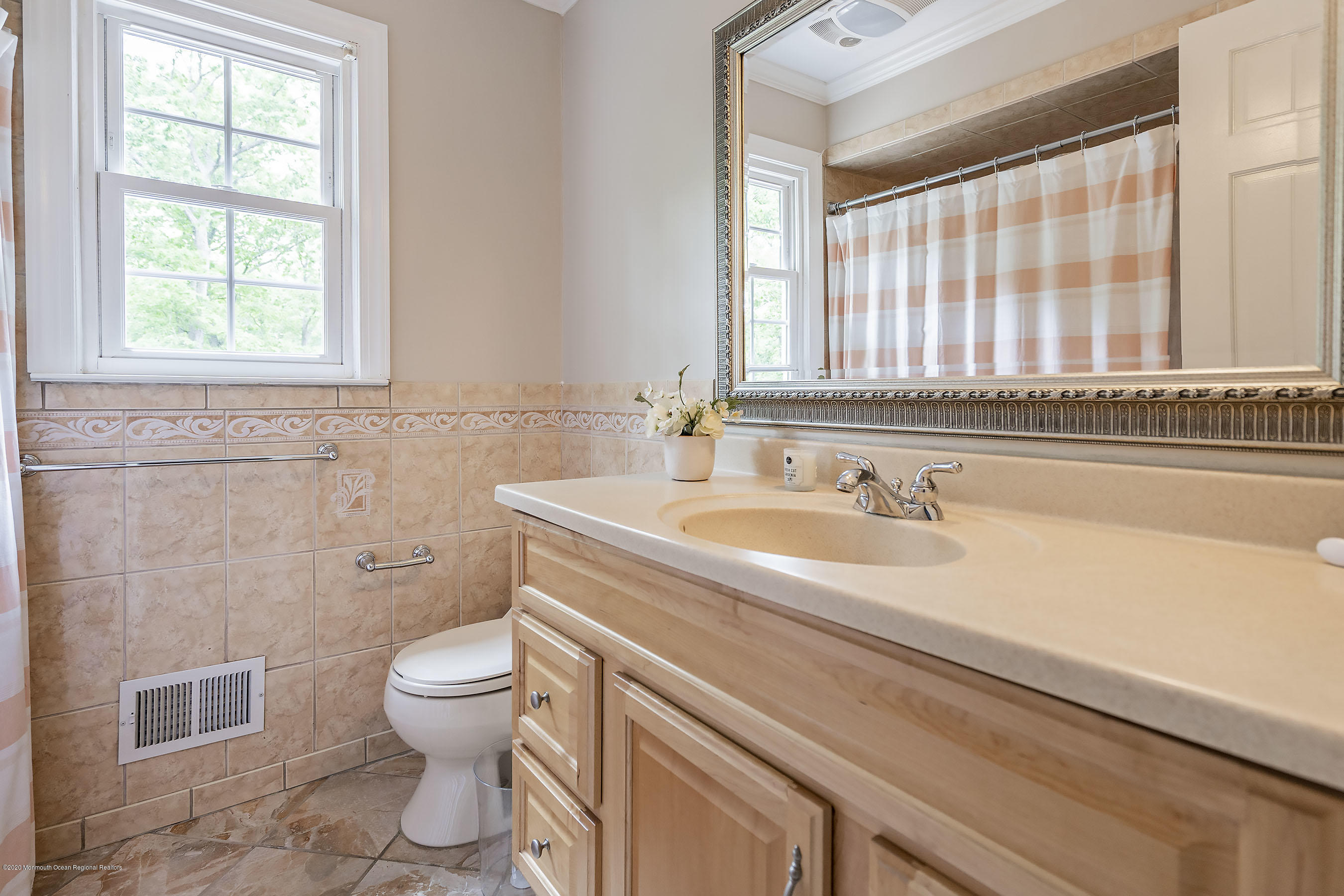702 Green Valley Road Jackson, NJ 08527 - Photo 21 of 37 a bathroom with a granite countertop sink a toilet and a window