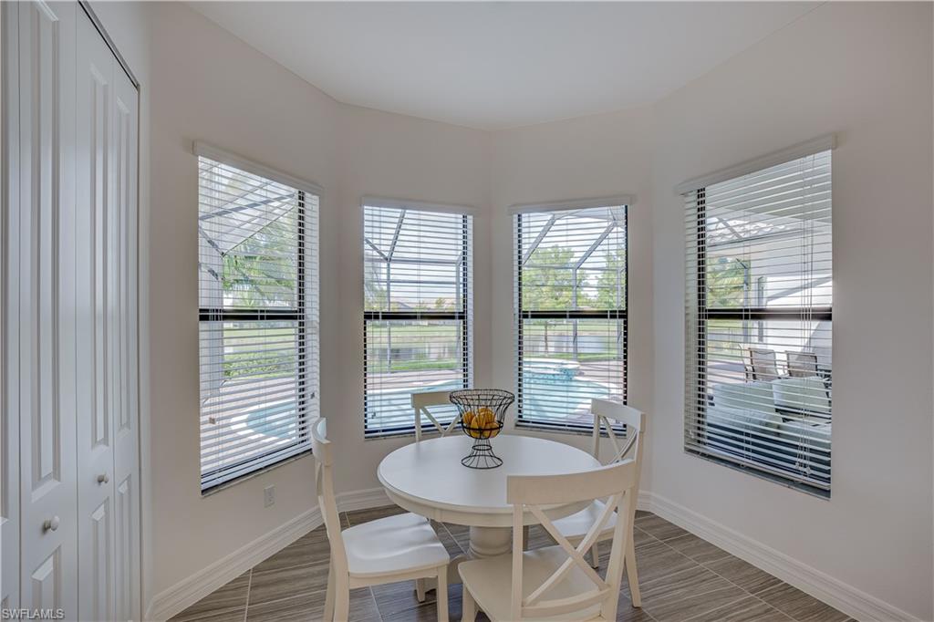 4549 Azalea Drive Naples, FL 34119 - Photo 13 of 25 a dining room with furniture and window