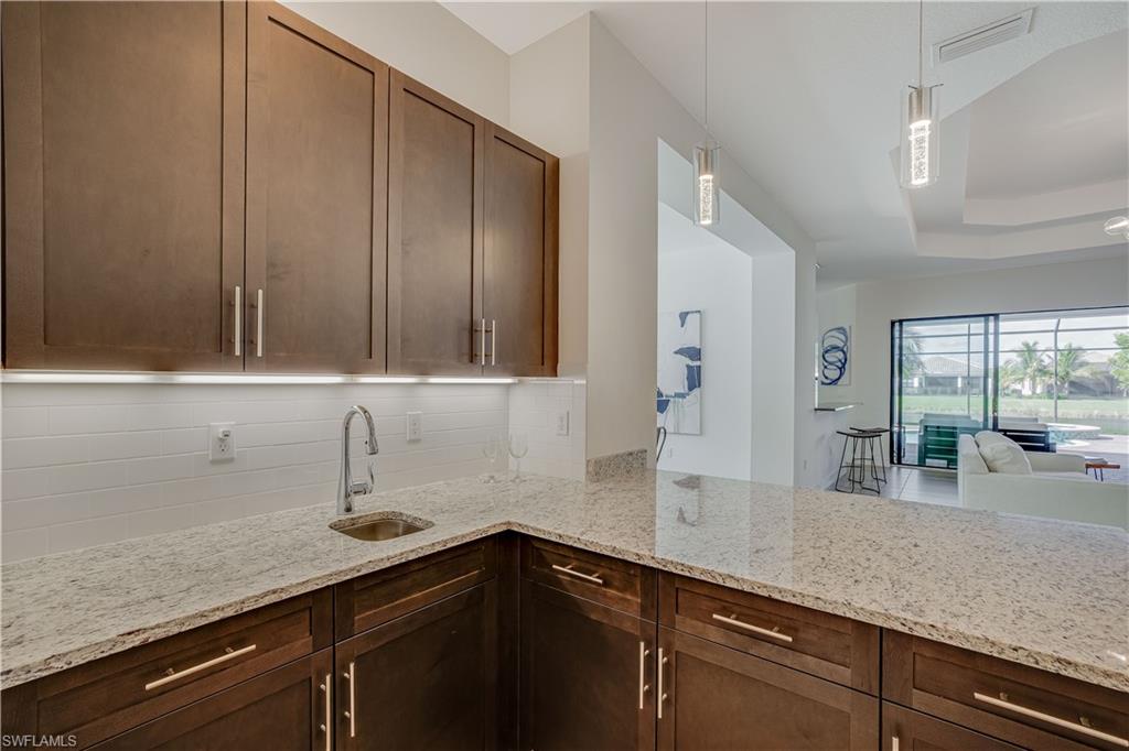 4549 Azalea Drive Naples, FL 34119 - Photo 16 of 25 a kitchen with sink and cabinets