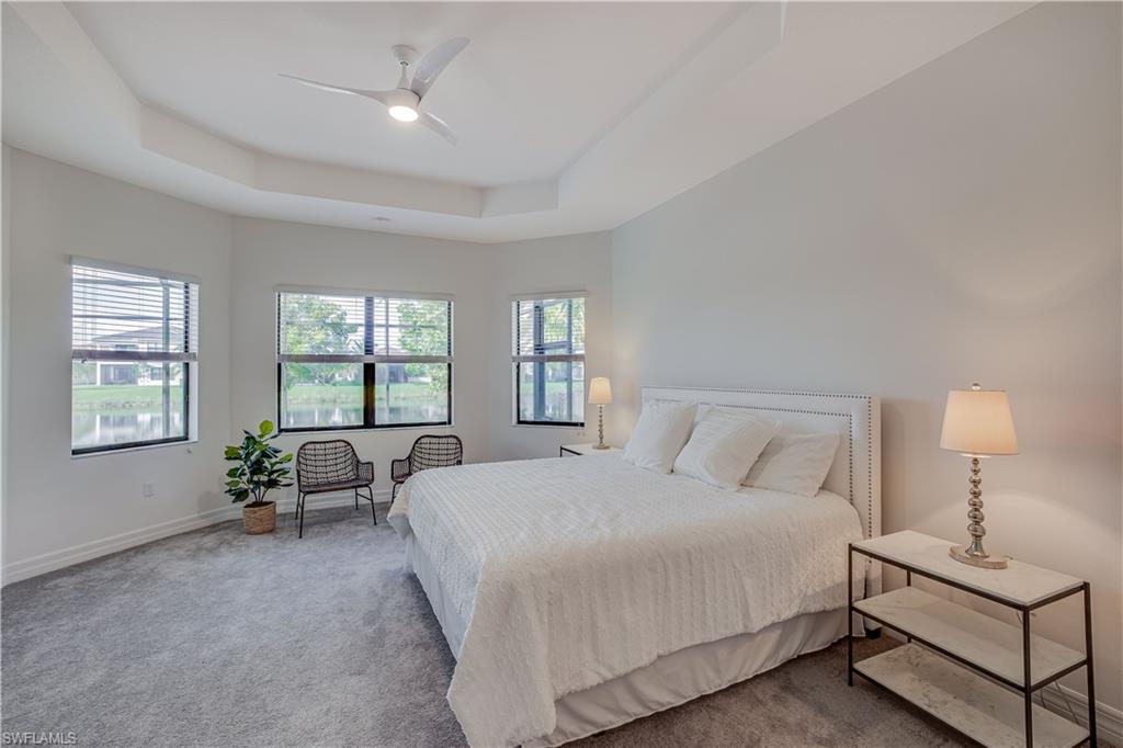 4549 Azalea Drive Naples, FL 34119 - Photo 17 of 25 a bedroom with a bed a couch and window